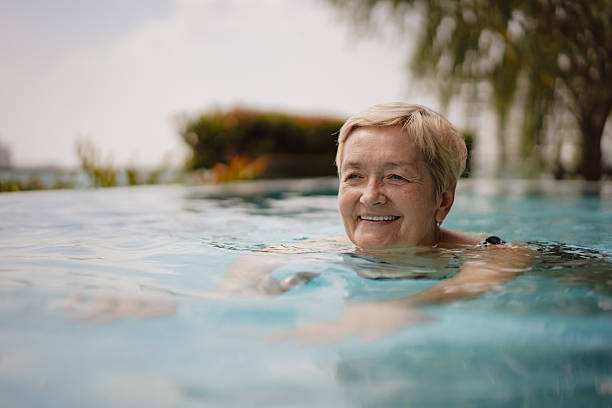 istock Senior woman swimming in a pool 2252169103