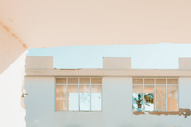 Interior and exterior views of a ruined, abandoned seaside hotel showing structural damage, debris, broken ceilings and empty corridors. The images symbolize decay, forgotten tourism infrastructure, economic decline and the passage of time in once-popular holiday destinations.