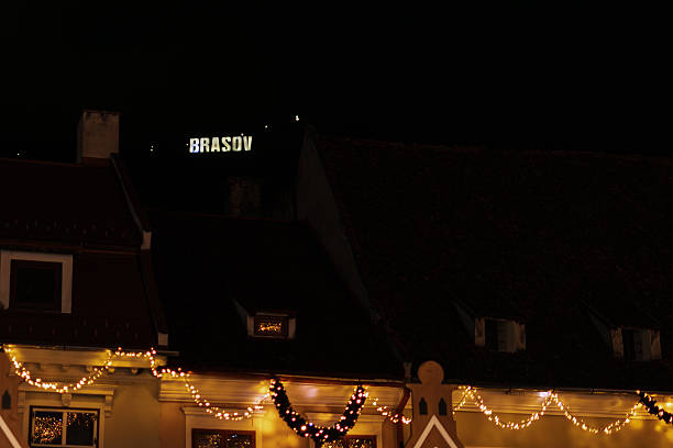 istock Illuminated Brasov Sign Over Old Town Rooftops with Christmas Lights 2252169863
