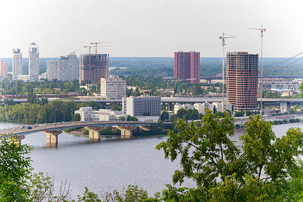 istock wide panorama city scape development country industry view river side district with cargo and working objects unfinished high rise buildings and bridge across the river of Dnieper in Ukraine 2252174917