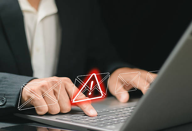 istock A businessman using a computer to receive email warning alerts about spam, junk and trash mail, hacker and virus. Concepts of network security 2252177564