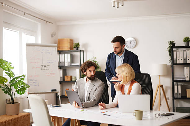 istock Business team engages in teamwork and brainstorming session in modern office space during day 2252178500