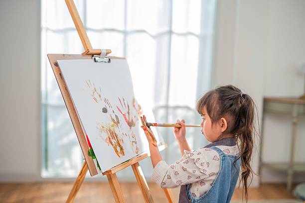 istock Child creates colorful art with handprints in a bright indoor space during daytime 2252179681