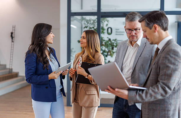 istock Business people collaborating in office meeting with technology 2252181247