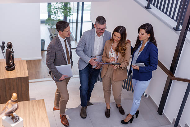 istock Business team discussing digital tablet content on office stairs 2252181261