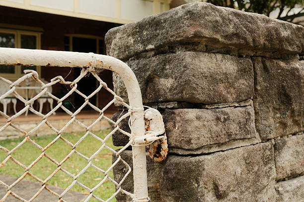Old closed rusty beige metal gate.
