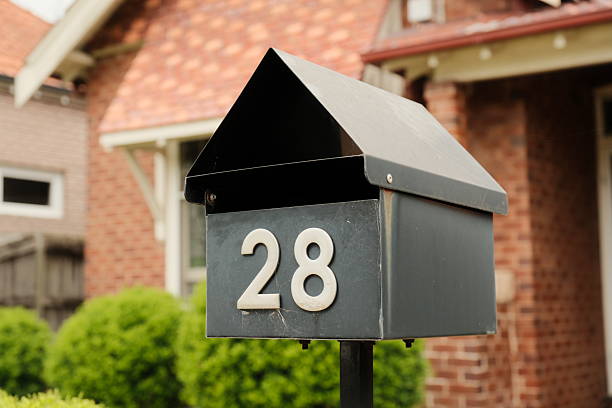 istock Old faded metal mailbox in a front yard 2252181575