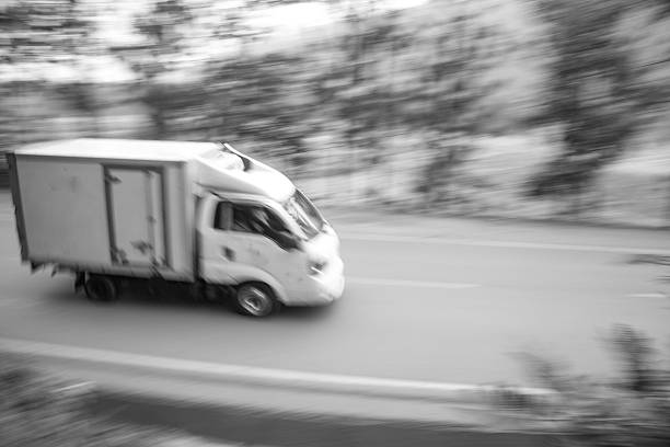 istock Logistics in Motion: Delivery Box Truck Speeding Down Road 2252181621