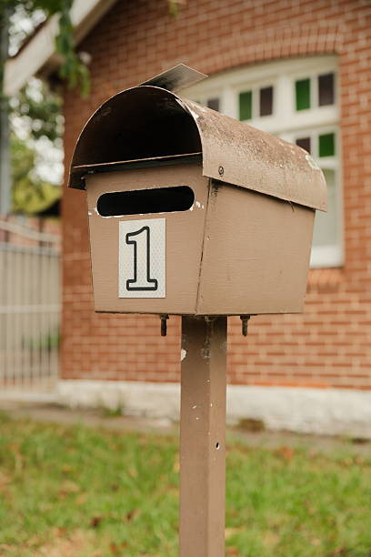 istock Old dirty brown metal mailbox on a pole 2252181642