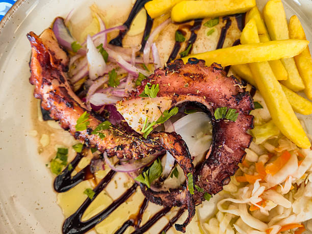Grilled octopus tentacles on the plate in a restaurant in Greece.