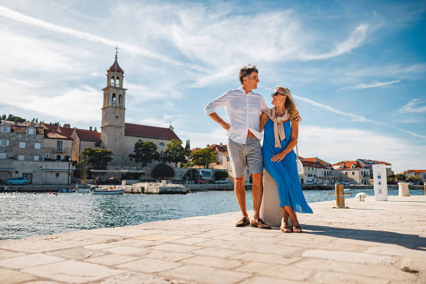 istock Relaxed Caucasian Couple Strolling Along Sutivan Promenade 2252184082