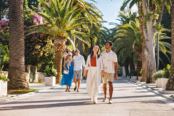 istock Happy Couple Strolling Along Palm Lined Sutivan Street Together 2252184143