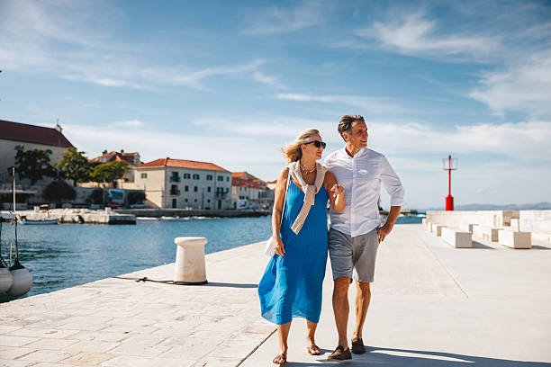 istock Mature Caucasian Couple Walking Under Blue Sky by Sutivan Harbor 2252184242
