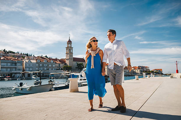 istock Relaxed Mature Couple Enjoying Walk by Adriatic Harbor 2252184255