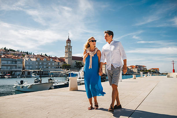 istock Joyful Mature Caucasian Pair Strolling by Adriatic Marina 2252184264