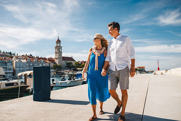 istock Relaxed Caucasian Couple Strolling on Adriatic Dockside in Sunshine 2252184279