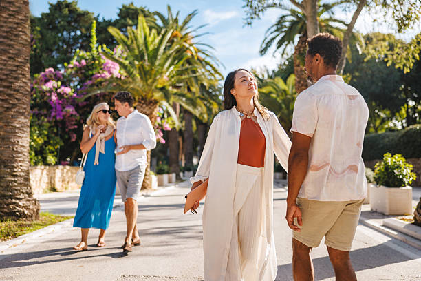 istock Couples Relishing Sunny Walk Among Palm Trees in Dalmatia 2252184391