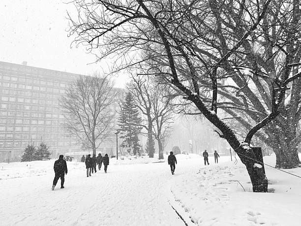 istock Silhouetted Commuters Walking Through Heavy Snowfall in Urban Sapporo, Japan  Black and White 2252186797