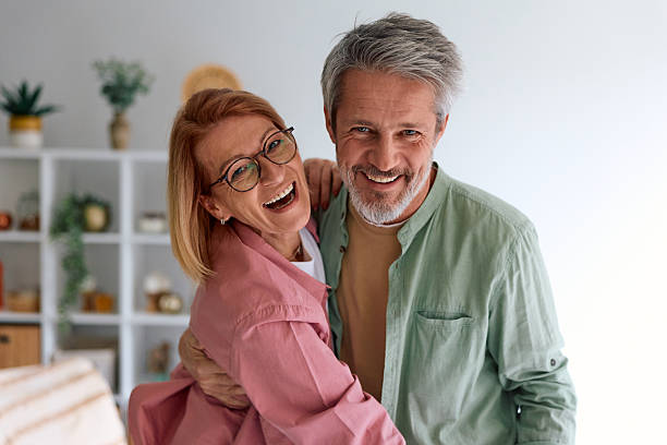 istock Happy mature couple embracing smiling at camera 2252188095