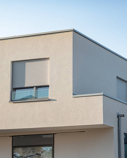 istock Modern residential building with sleek design features under clear blue sky during late afternoon 2252191761