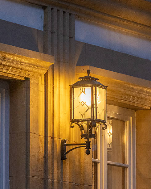 istock Beautiful wall-mounted lantern illuminating a historic building in the evening light 2252191769