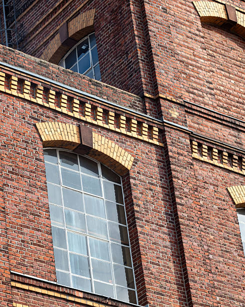istock Historic brick building with large windows showcasing architectural details in urban setting during sunny day 2252191833