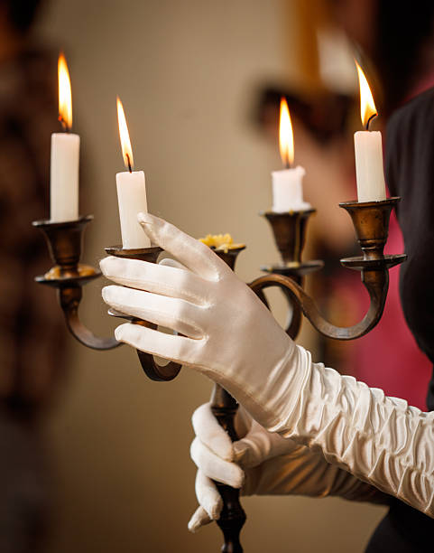 istock A woman is holding a candle holder with three candles in it 2252194607