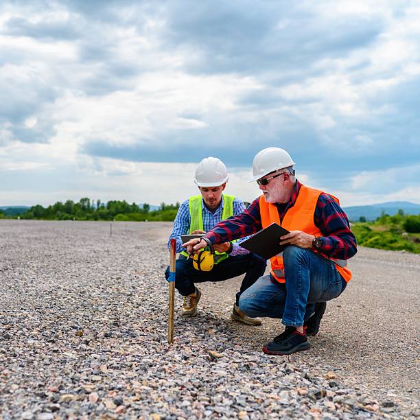 istock Two engineers check the PIN against the road plan 2252196100