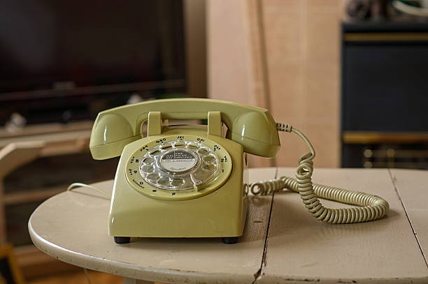 landline phone on a table with a defocused home background