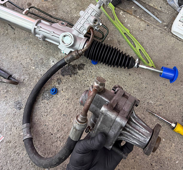 istock A mechanic holds a steering pump while working on a rack in a garage environment 2252197191