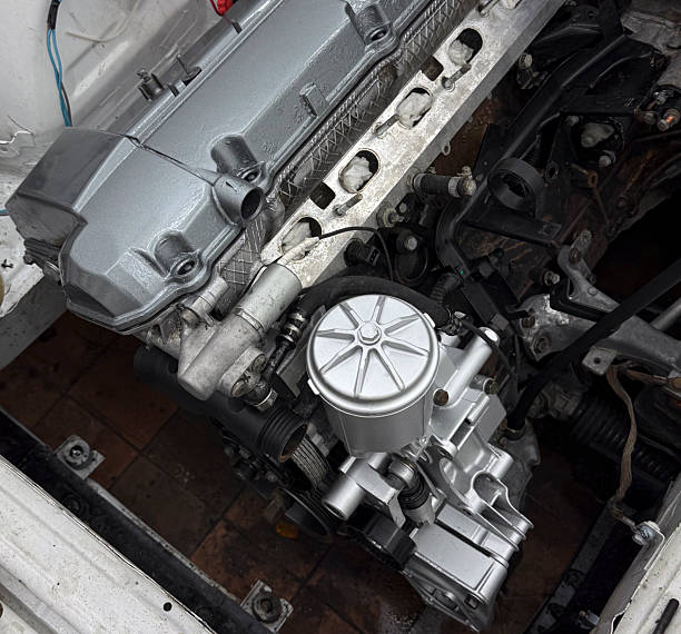 istock A car engine is being assembled in an auto shop, showcasing various parts and tools 2252197199