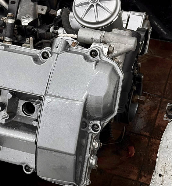 istock Engine parts are being repaired in a garage with tools spread around and natural light coming in 2252197200