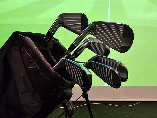 istock Golf clubs are ready for practice in indoor setting with a screen in the background 2252198501