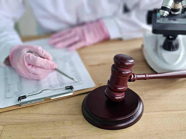 istock Legal professional conducting analysis with hammer and microscope 2252200720