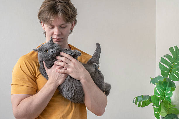 istock Caring for pet cat at home . Man Spending Time with His Cat at Home 2252200833