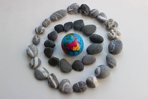 istock The Asian Continent is Visible on a Globe Inside Two Circles of Gray Pebbles with Different Structures 2252204077