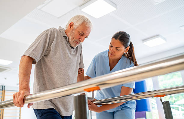 istock Senior man doing physical therapy and walking on bars 2252206204