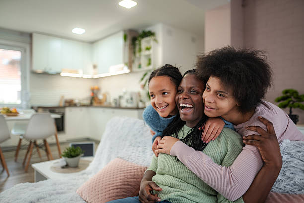 istock Black mother and daughters enjoying happy moment embracing 2252208332