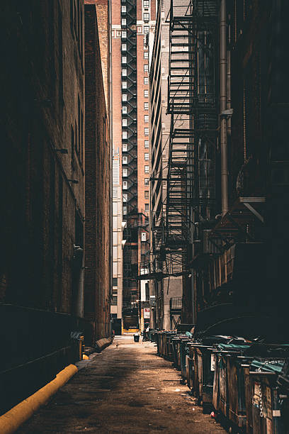 istock Dark Urban Alley with Fire Escapes 2252209304