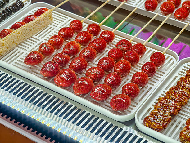 Glazed Strawberries on Skewers Displayed in a Bright Setting