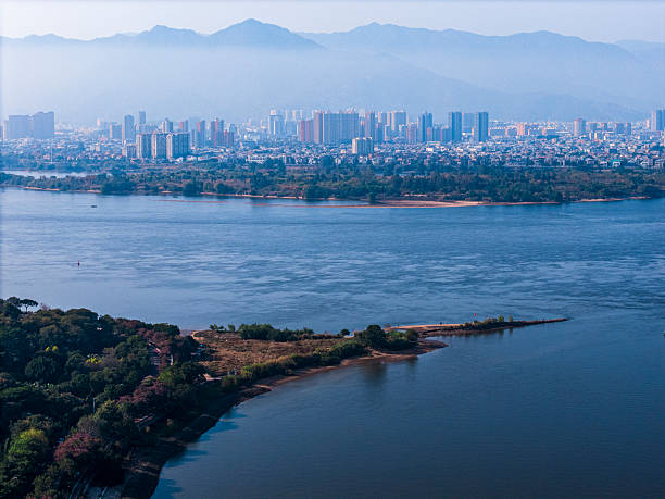istock A serene lakeside view with distant mountains and urban landscape 2252210464