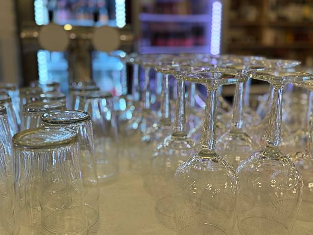 istock Glassware arrangement with empty wine glasses and beer glasses in bar setting background 2252210615