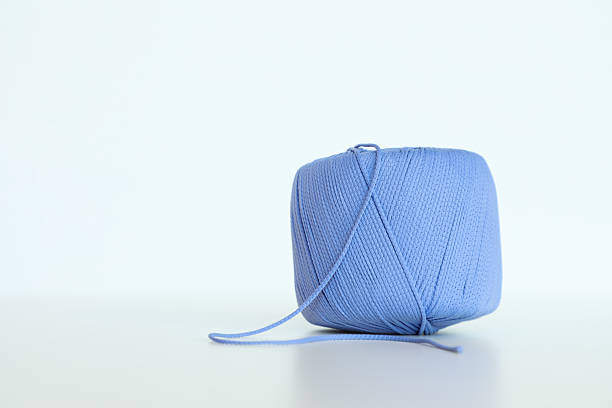 Textured yarn spool representing handmade creativity, crafts, knitting, and DIY. Ideal for themes related to home crafts, knitting projects, and creative inspiration.