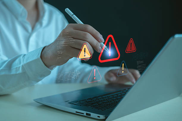 istock Cybersecurity alert concept showing professional interacting with digital warning icons on laptop, symbolizing system risk, data threats, security notifications, and IT protection awareness. 2252212981