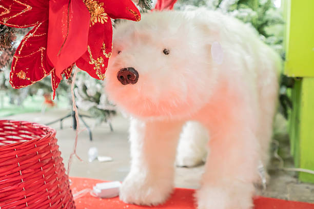 Decorative cute polar bear under a Christmas tree Christmas tree in a festive interior