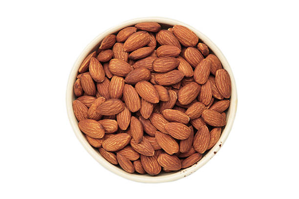 istock Almonds in white bowl isolated on white background 2252215723