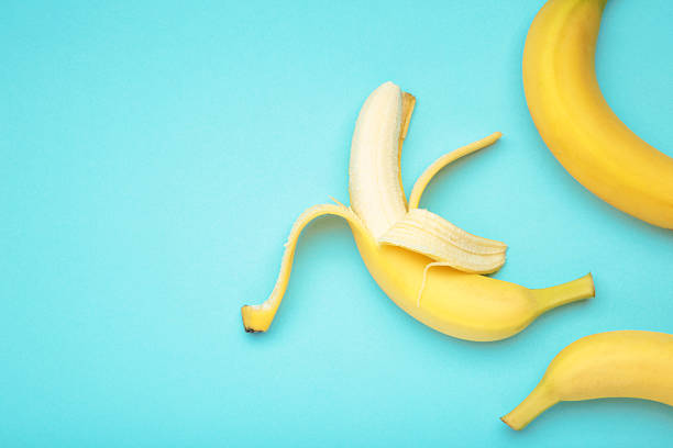istock Open ripe banana on blue background. Space for text 2252215731