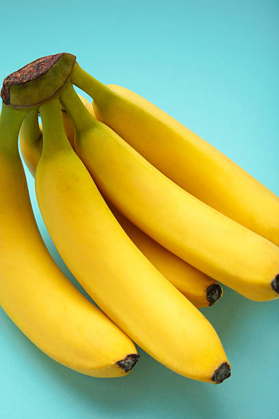 istock Bunch of bananas on mint background. Top view. Vertical photo 2252215764