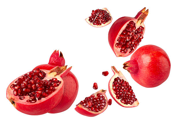 Falling Pomegranate fruit isolated on white background with clipping path, full depth of field