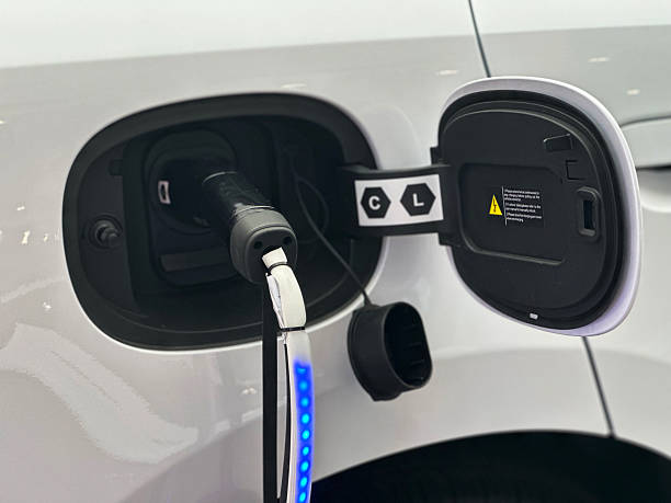 Close-up of an electric vehicle charging port with open flap, highlighting EV charging interface and sustainable transportation technology.